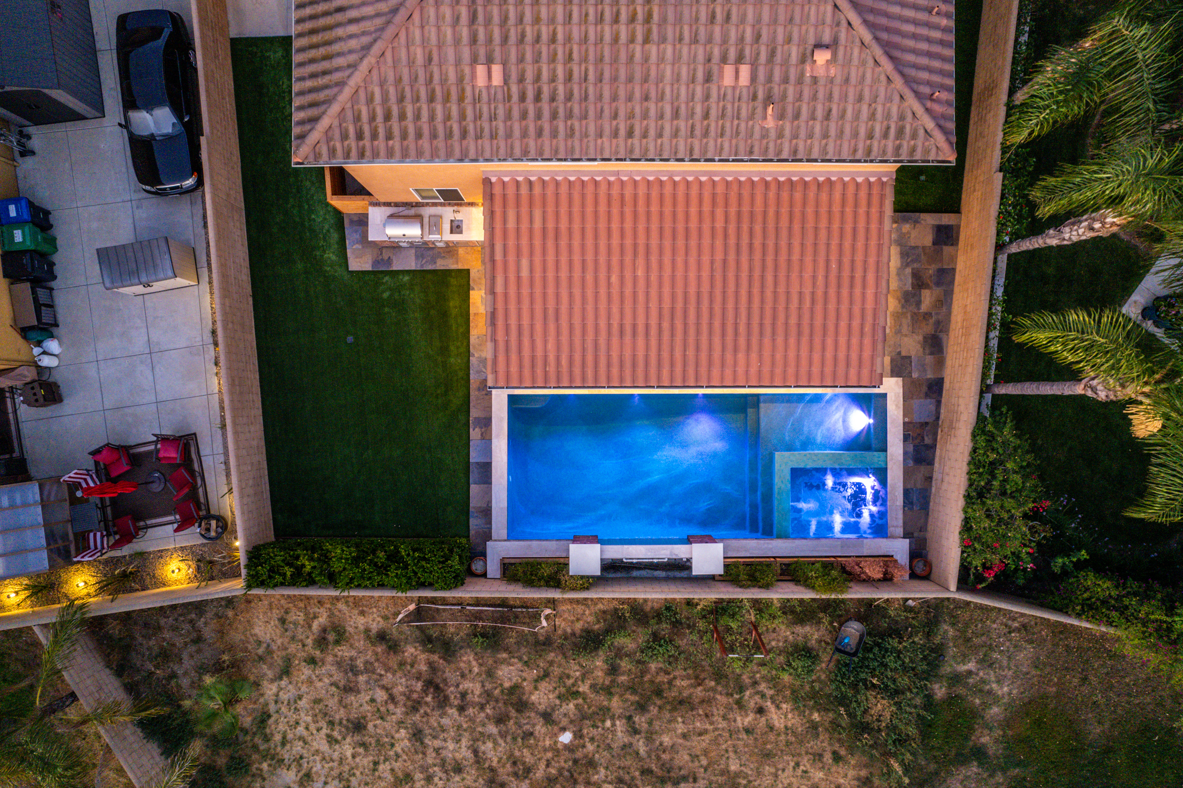 Aerial view of a new pool and spa lit at night
