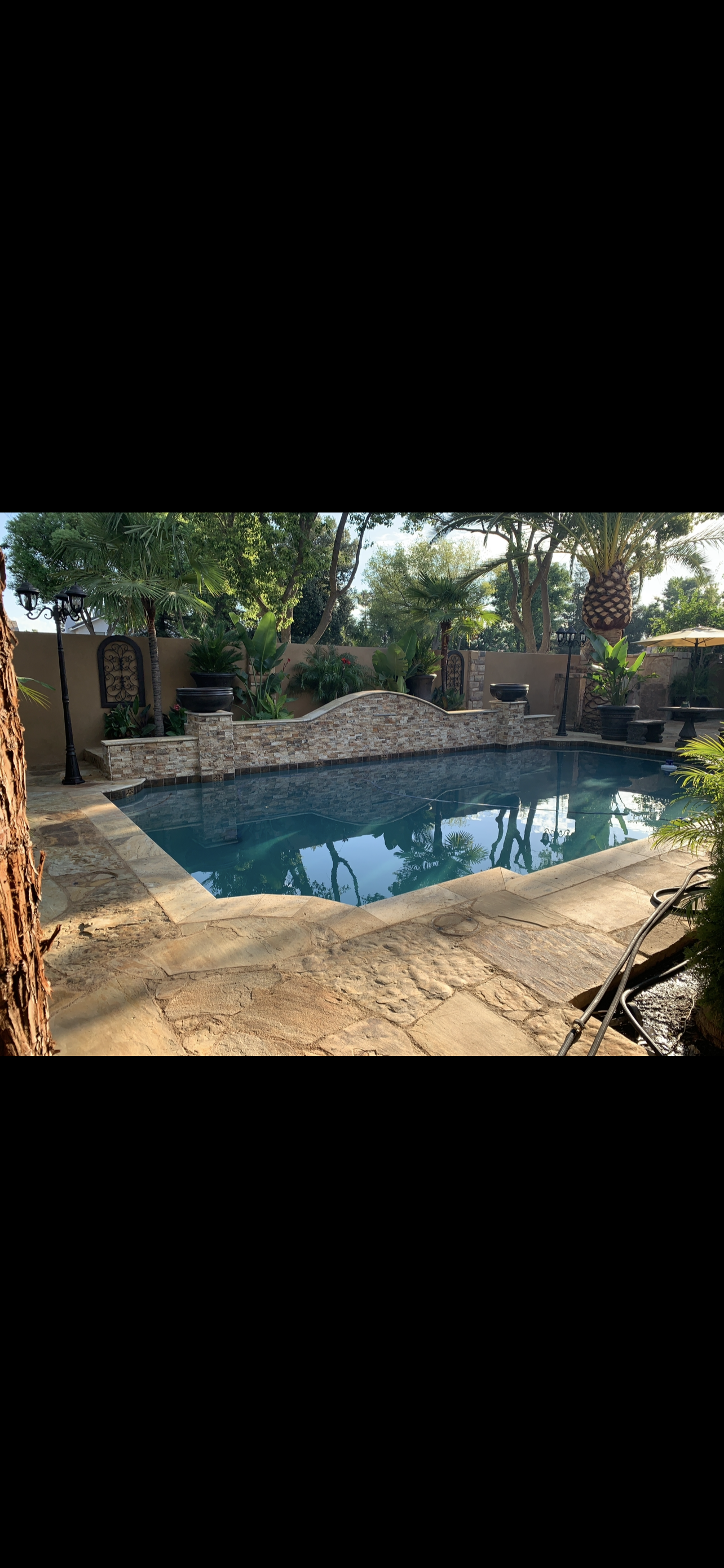 Renovated grecian pool with stacked stone wall