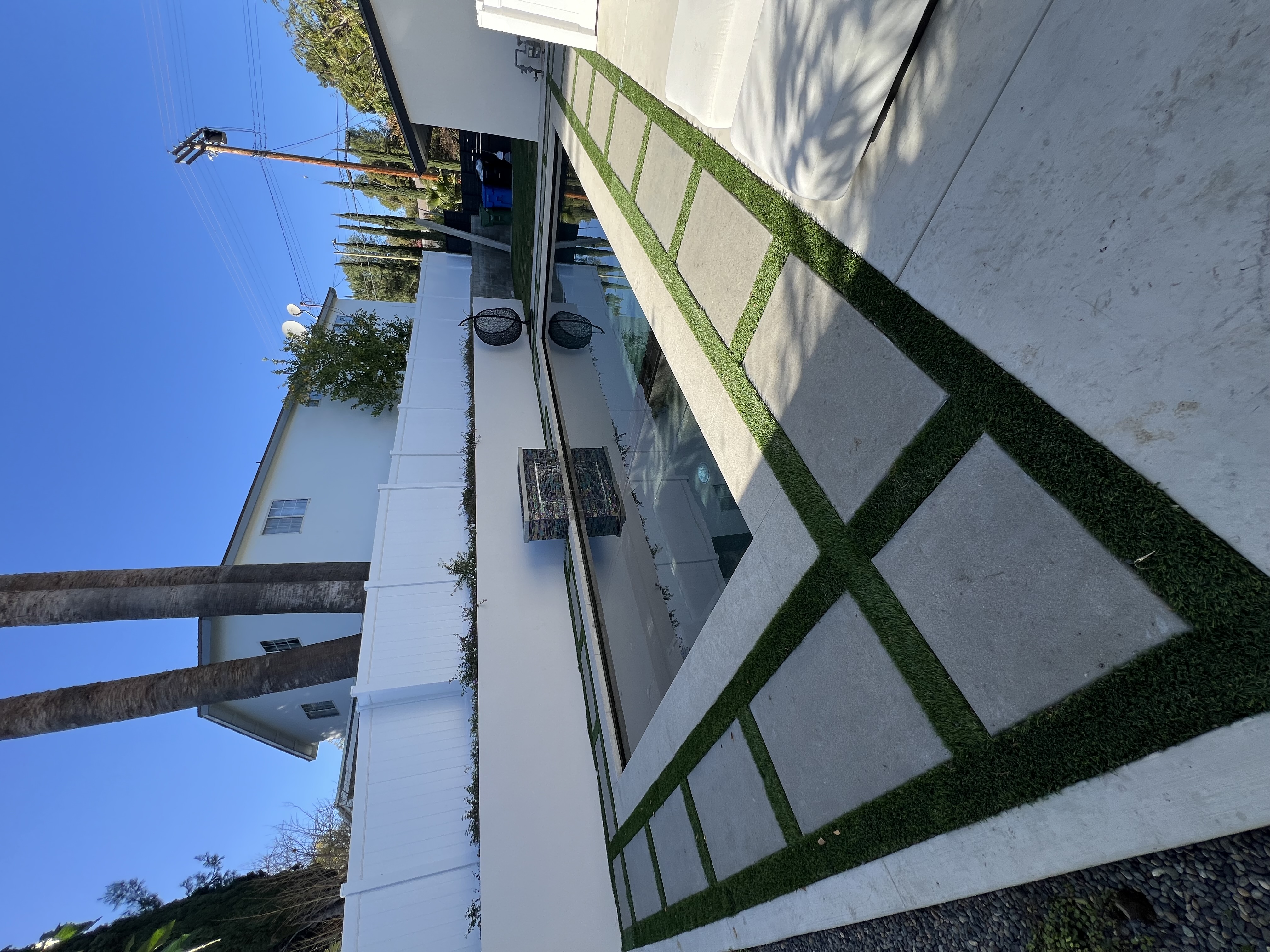Modern pool with paver and turf grid deck