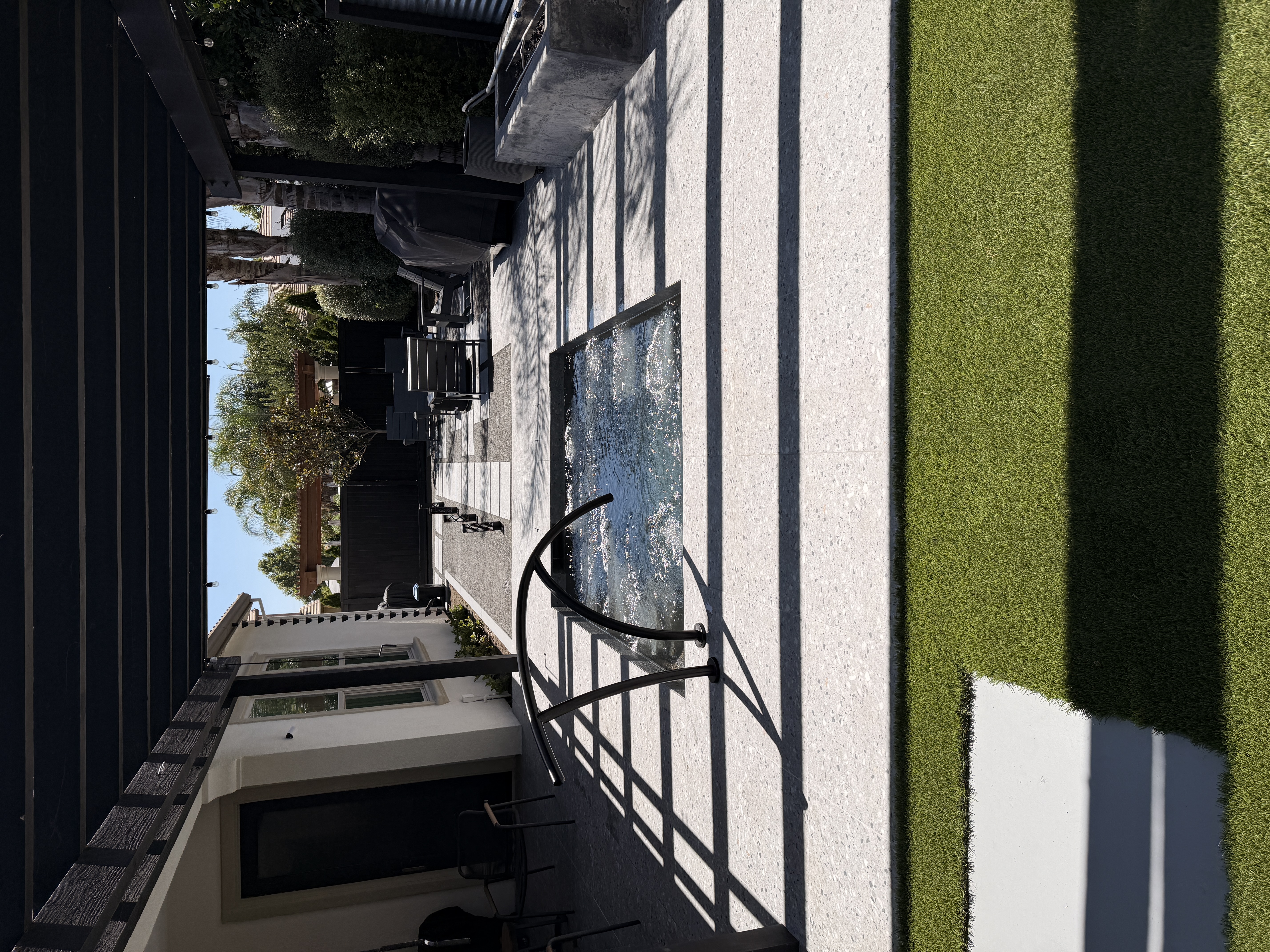 Modern in-ground spa with arc rail