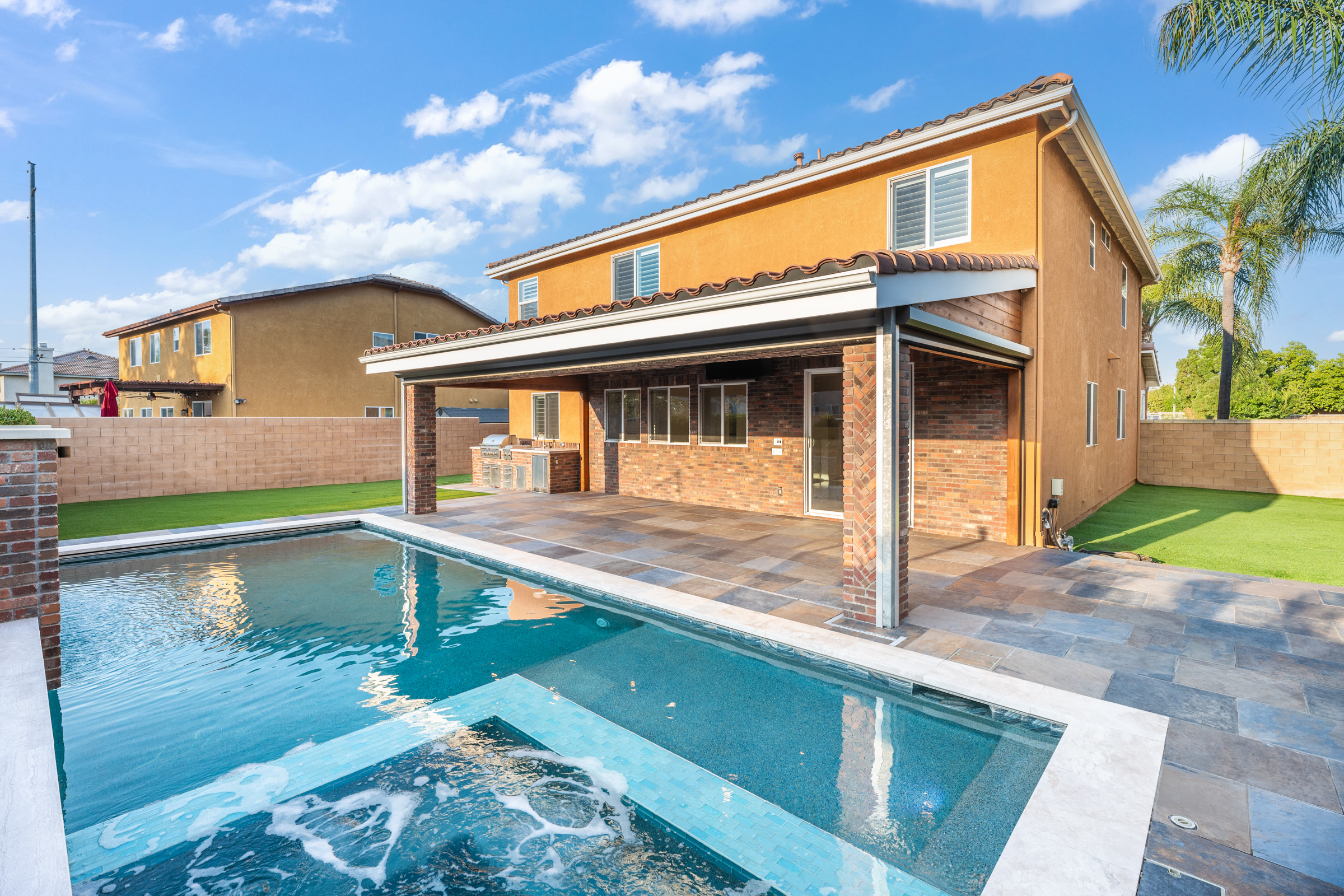 Custom pool and spa with covered outdoor kitchen on a Loomis parcel