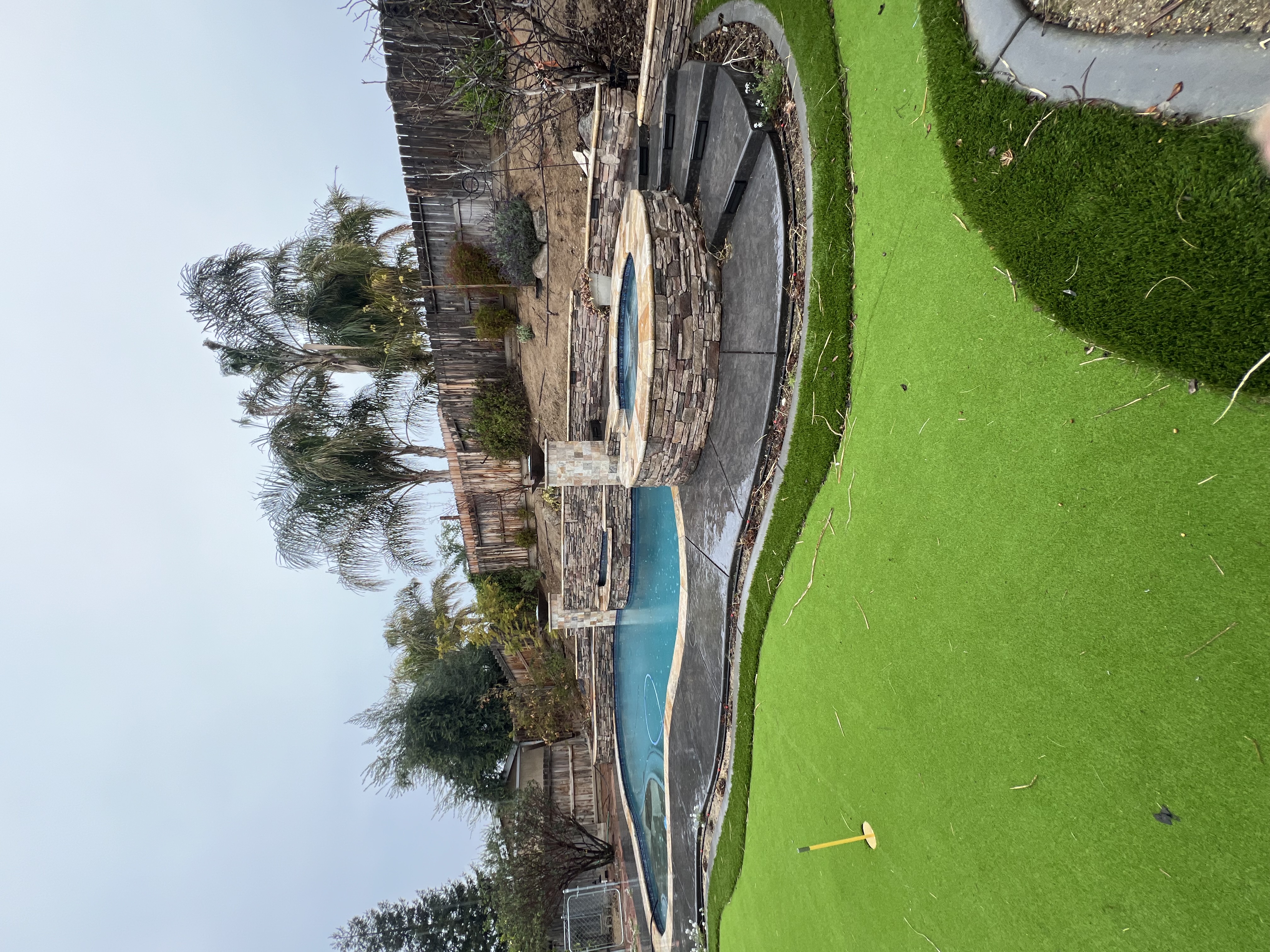 Pool, raised stone spa and putting green