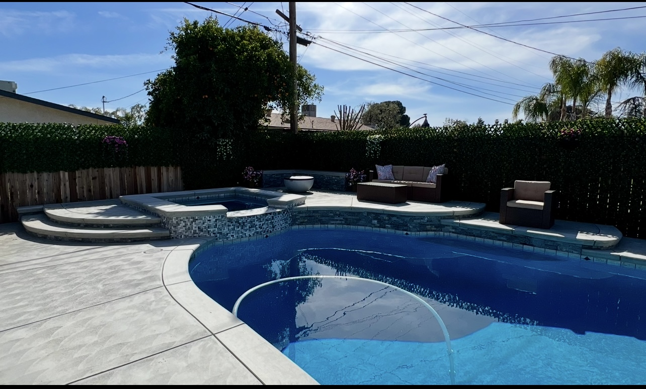 Spa addition with glass mosaic tile on existing pool